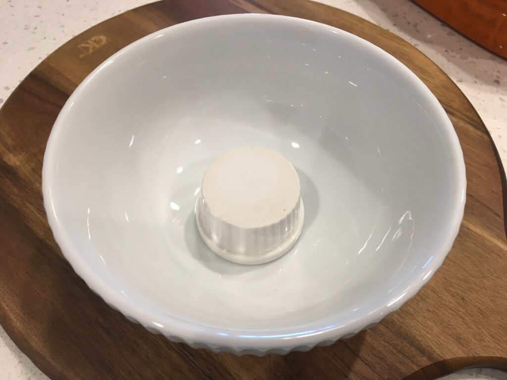 Place a ramekin upside down in a wide bowl.