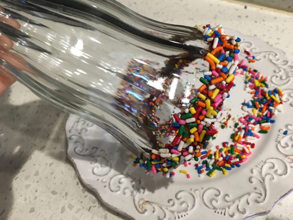 Immediately roll in the rainbow sprinkles until coated.