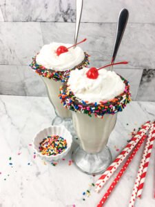 Pour the milkshake into decorated glasses.
